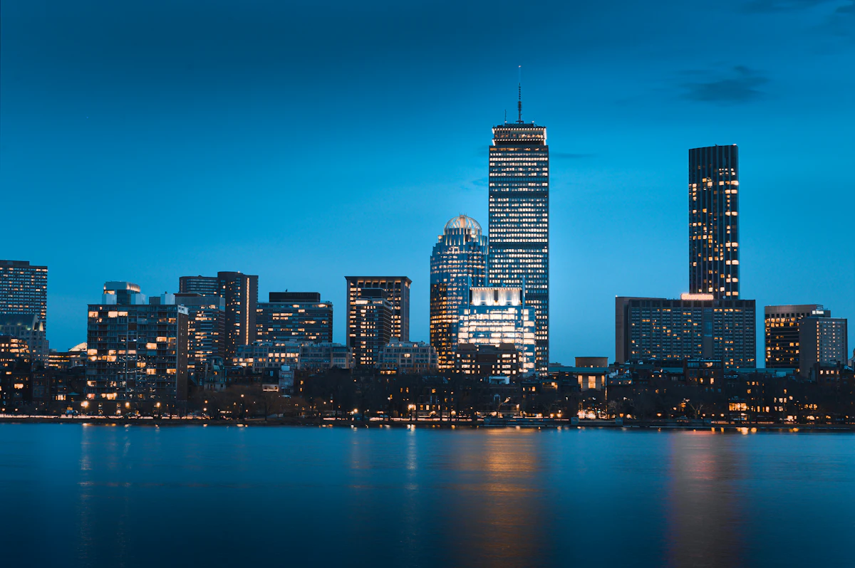 The Boston skyline at night across the harbor
